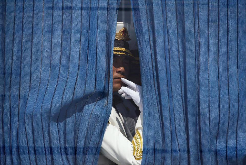 A member of the honor guards waits in a bus for the arrival of U.S. President Barack Obama