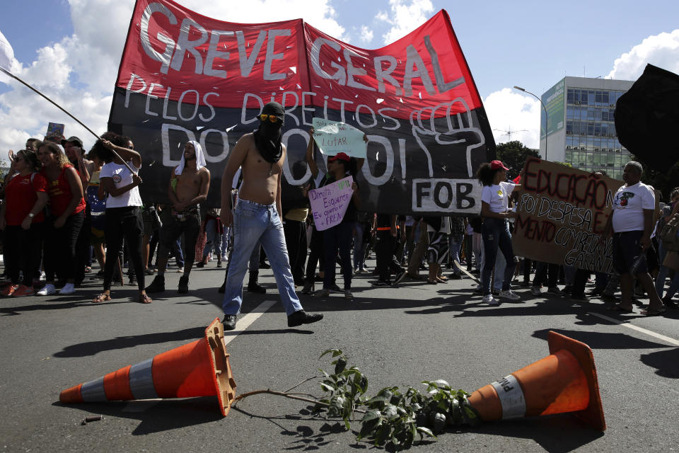 Demonstrators set up a barricade during nation-wide education strike, in Brasilia, Brazil, Wednesday, May 15, 2019. Federal education officials this month announced budget cuts of $1.85 billion for public education, part of a wider government effort to slash spending. (AP Photo/Eraldo Peres)