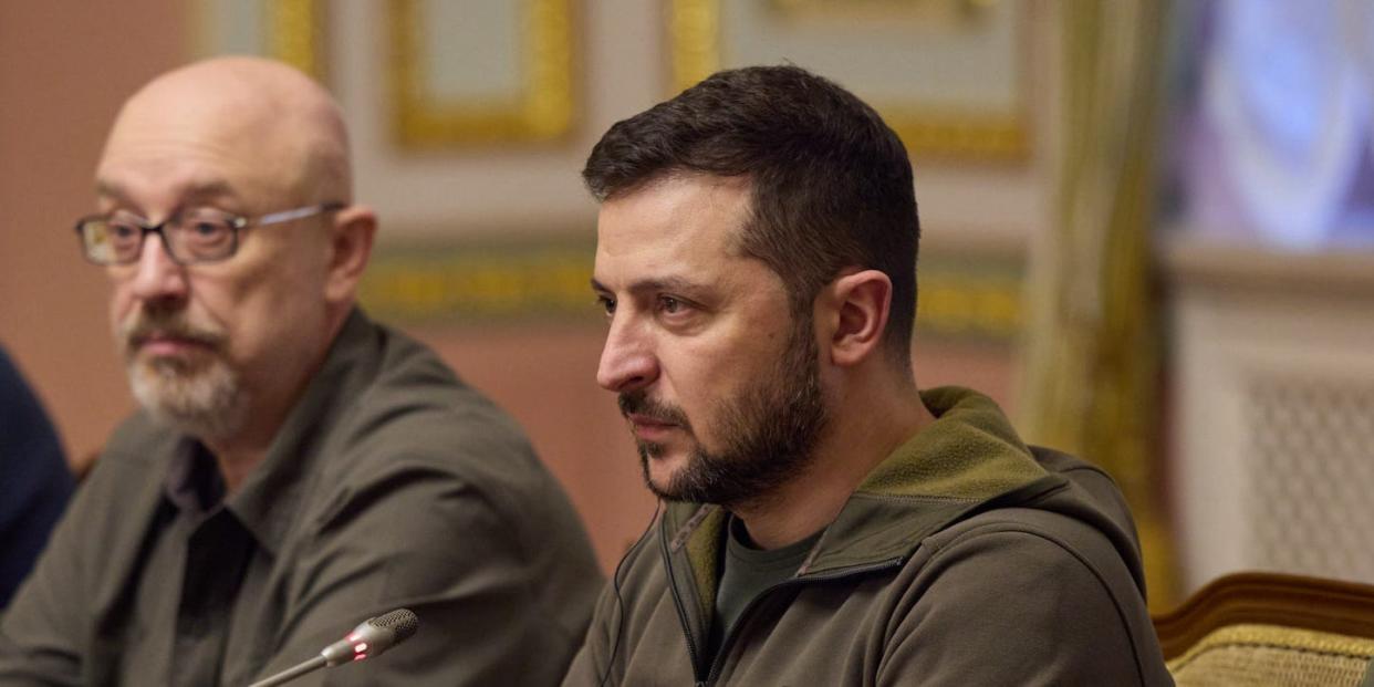 President Volodymyr Zelenskyy seated at a conference table with two Ukrainian officials in Kyiv, November 3, 2022.