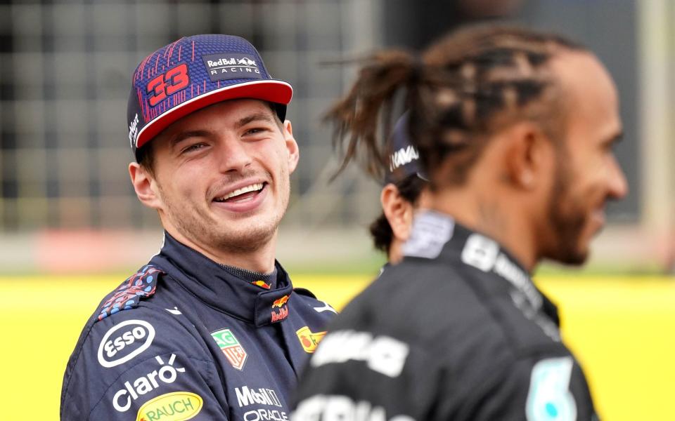 Max Verstappen laughs next to Lewis Hamilton - PA