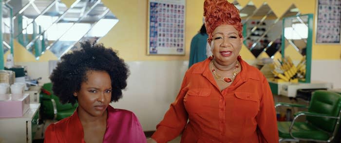 Two women in a salon staring with narrowed eyes at someone off camera