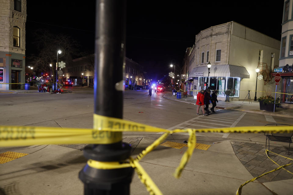 Police canvass the streets in downtown Waukesha, Wis., after a vehicle plowed into a Christmas parade hitting more than 20 people Sunday, Nov. 21, 2021. (AP Photo/Jeffrey Phelps)
