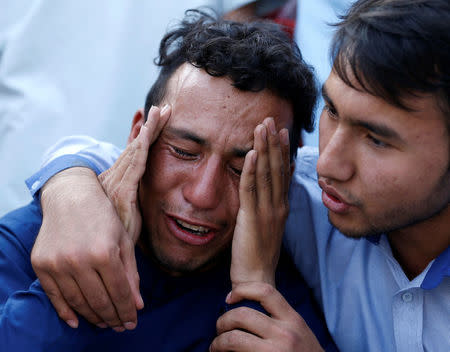 An Afghan man weeps outside a hospital after a suicide attack in Kabul, Afghanistan July 23, 2016. REUTERS/Mohammad Ismail