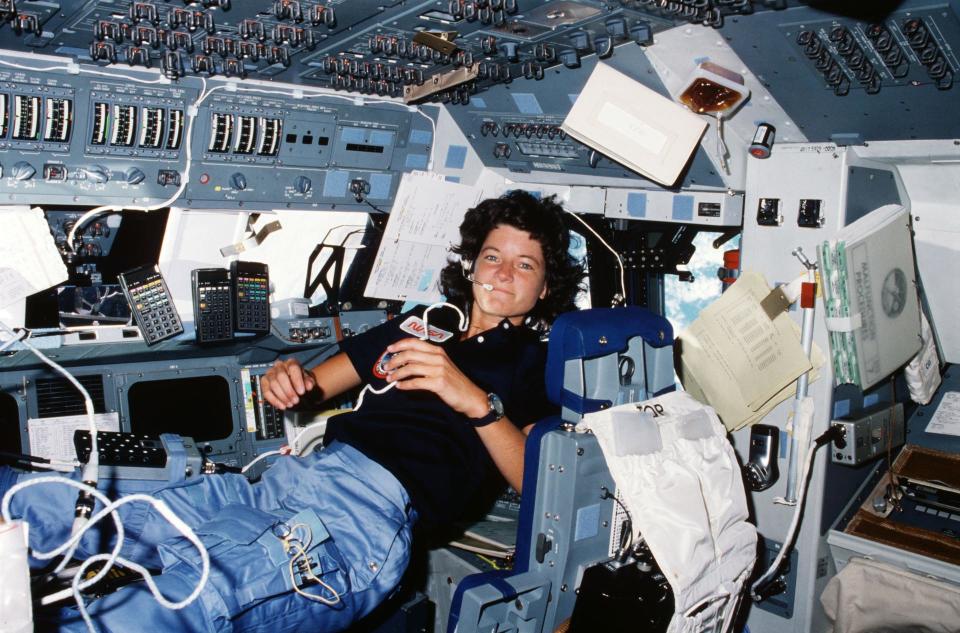 Astronaut Sally K. Ride, STS-7 mission specialist and the first American woman in space, performs a number of functions simultaneously, proving the necessity for versatility and dexterity in space. Floating freely on the flight deck of shuttle Challenger, Ride communicated with ground controllers in Houston during this 1983 mission. She was one of the five astronaut crew members for the Challenger’s second orbital mission.