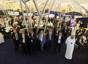 Participants at the Future Investment Initiative forum watch a live screen during the opening session in Riyadh, Saudi Arabia, Tuesday, Oct. 29, 2019. The long-planned initial public offering of a sliver of Saudi Arabia’s state-run oil giant Saudi Aramco will see shares traded on Riyadh’s stock exchange in December, a Saudi-owned satellite news channel reported Tuesday as the kingdom’s marquee investment forum got underway. (AP Photo/Amr Nabil)