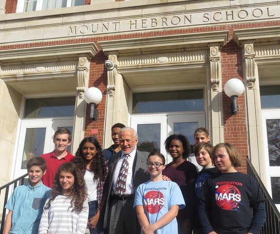 Apollo 11 moonwalker Buzz Aldrin poses with students on the stairs of the former Mount Hebron Middle School in Montclair, New Jersey, in October 2015. The school is being renamed the Buzz Aldrin Middle School,