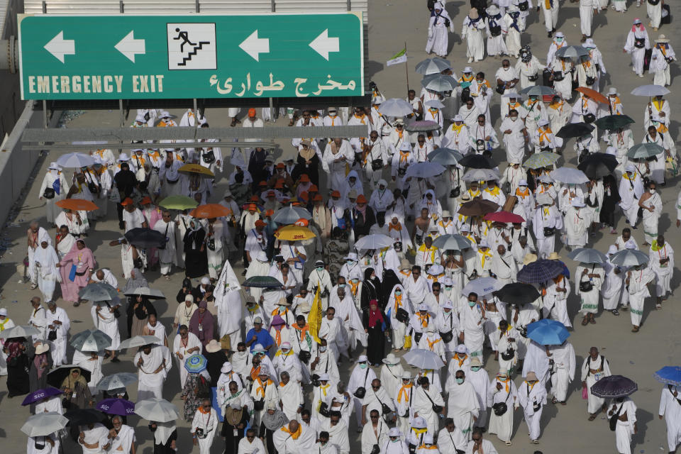 Pilgrims walk to cast stones at a pillar in the symbolic stoning of the devil, the last rite of the annual Hajj pilgrimage, in Mina near the holly city of Mecca, Saudi Arabia, Wednesday, June 28, 2023. (AP Photo/Amr Nabil)