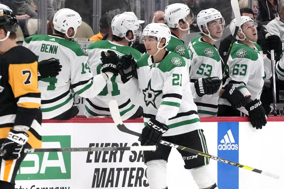 Dallas Stars' Jason Robertson (21) returns to the bench after scoring against the Pittsburgh Penguins during the second period of an NHL hockey game in Pittsburgh, Tuesday, Oct. 24, 2023. (AP Photo/Gene J. Puskar)
