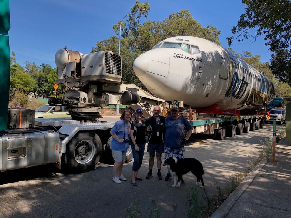 The plane being transported to the air park.