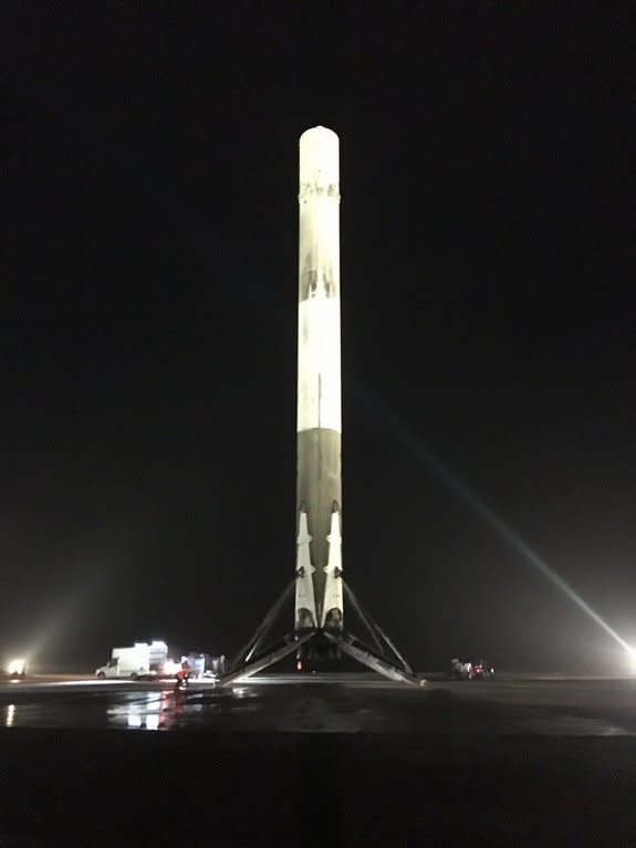 The first stage of SpaceX's Falcon 9 rocket stands triumphantly on Landing Site 1 at Cape Canaveral Air Force Station in Florida after successfully launching into orbit and returning to Earth on Dec. 21, 2015.