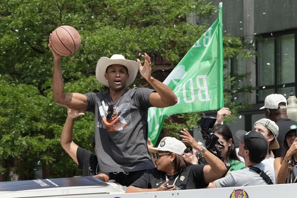 Boston Celtics' Al Horford celebrates the teams NBA basketball championship win during a duck boat parade Friday, June 21, 2024, in Boston. (AP Photo/Michael Dwyer)