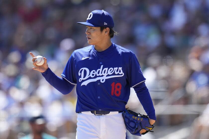 Los Angeles Dodgers starting pitcher Yoshinobu Yamamoto, of Japan, communicates with the infielders during the second inning of the team's spring training baseball game against the Seattle Mariners on Wednesday, March 13, 2024, in Phoenix. (AP Photo/Ross D. Franklin)