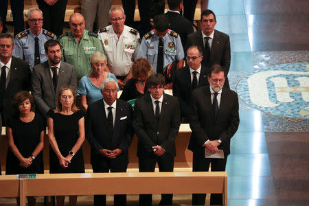 Portuguese Prime Minister Antonio Costa, President of the Generalitat of Catalonia Carles Puigdemont and Spanish Prime Minister Mariano Rajoy are seen as High mass is celebrated in the Basilica of the Sagrada Familia in memory of the victims of the van attack at Las Ramblas in Barcelona earlier this week, Spain August 20, 2017. REUTERS/Sergio Perez