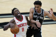 Houston Rockets forward Jae'Sean Tate (8) is fouled by San Antonio Spurs forward Keldon Johnson (3) during the second half of an NBA basketball game in San Antonio, Thursday, Jan. 14, 2021. (AP Photo/Eric Gay)