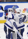 Tampa Bay Lightning goaltender Andrei Vasilevskiy (88) celebrates the win with Tampa Bay Lightning right wing Nikita Kucherov (86) against the Florida Panthers after the third period in Game 1 of an NHL hockey Stanley Cup first-round playoff series, Sunday, May 16, 2021, in Sunrise, Fla. (AP Photo/Joel Auerbach)