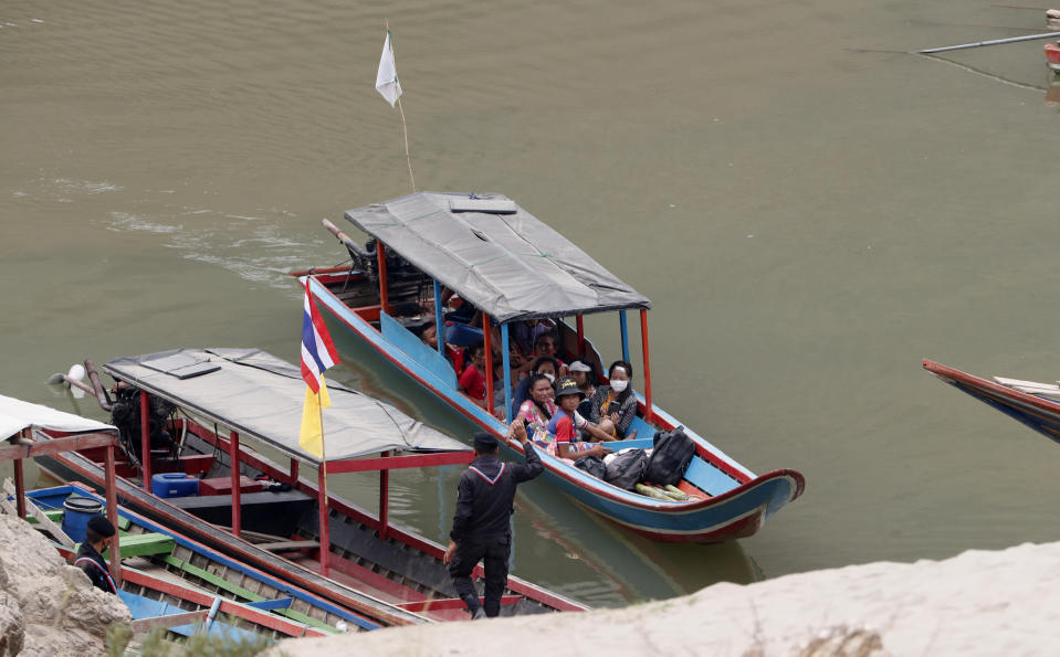 Karenni villagers from Myanmar arrive on a boat with an injured person as they evacuate to Ban Mae Sam Laep Health Center in Mae Hong Son province, northern Thailand on Tuesday March 30, 2021. Thai soldiers began sending back some of the thousands of people who have fled a series of airstrikes by the military in neighboring Myanmar, people familiar with the matter said Monday. But Thai officials denied that as the insecurity on the border added a new dimension to an already volatile crisis set off by a coup in Myanmar. (AP Photo/Sakchai Lalit)