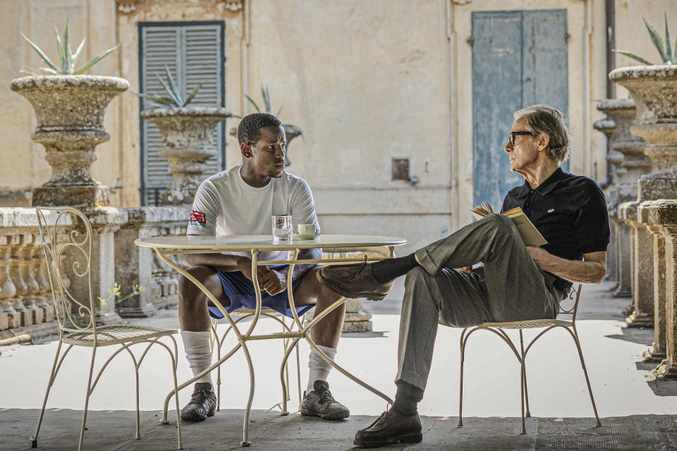 This image released by Netflix shows Micheal Ward, foreground left, and Bill Nighy in a scene from "The Beautiful Game." (Alfredo Falvo/Netflix via AP)