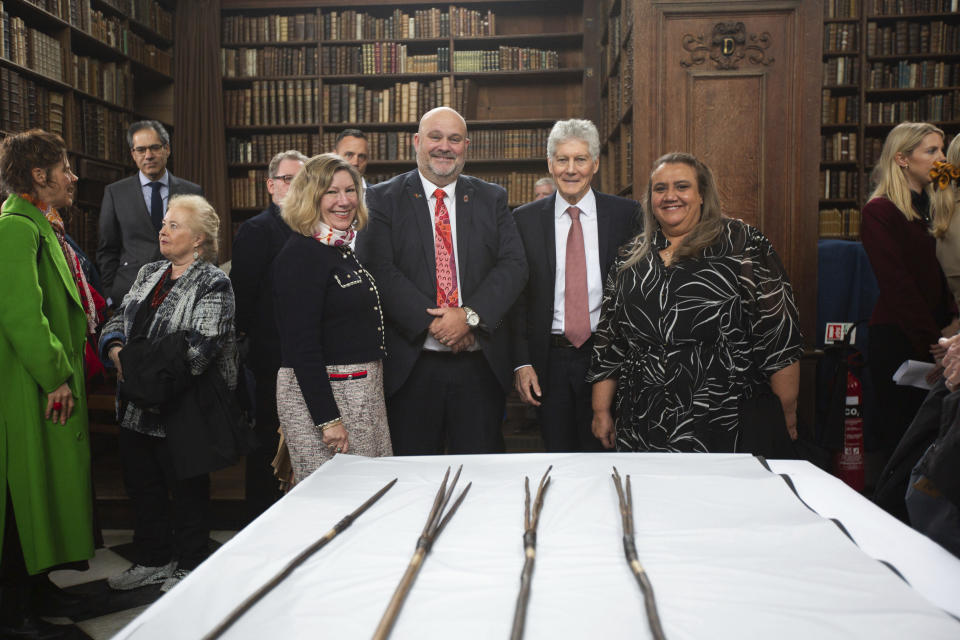 Undated handout photo issued by Cambridge University of Elisabeth Bowes, Leonard Hill, Stephen Smith and Noeleen Timbery with four Aboriginal spears that were brought to England by Captain James Cook more than 250 years ago and have now been repatriated to Australia in a ceremony at Trinity College in Cambridge, Tuesday April 23, 2024. (Cambridge University via AP)