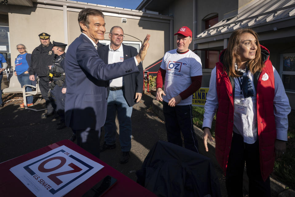 From left, Dr. Mehmet Oz arrives at Bryn Athyn Borough Hall to vote and greets Rob Davies candidate for Pennsylvania State Senate, Peter Sheedy, Republican Comitteee Chair Person, and Lorraine Ryan, treasurer for Rob Davies Pennsylvania State Senate candidate, in Huntingdon Valley, Pa., Tuesday, Nov. 8, 2022. (Jessica Griffin/The Philadelphia Inquirer via AP)