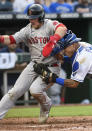 Boston Red Sox's Christian Arroyo, left, is tagged out at home by Kansas City Royals catcher Salvador Perez during the third inning of a baseball game in Kansas City, Mo., Friday, June 18, 2021. (AP Photo/Reed Hoffmann)