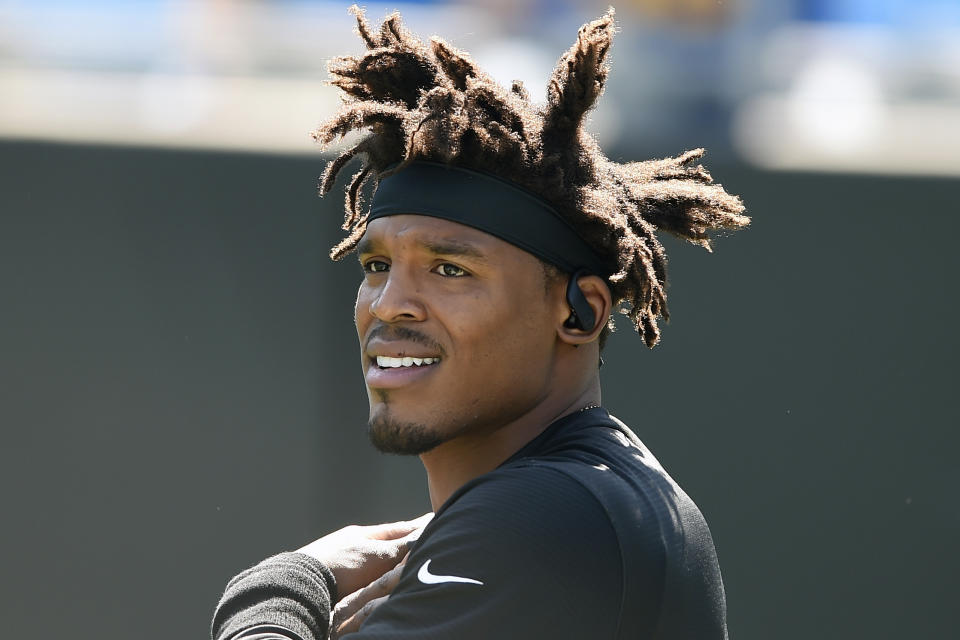 FILE - In this Sept. 8, 2019, file photo, Carolina Panthers quarterback Cam Newton (1) stretches prior to an NFL football game against the Los Angeles Rams in Charlotte, N.C. Even with the status of the upcoming season uncertain because of the coronavirus pandemic, teams continue to tinker with their rosters by adding players they hope will help them win — whenever, or if, they actually play. Newton is 31 and five years removed from his AP NFL MVP season, but he has been posting workout videos on Instagram to show he's now healthy. Where he eventually ends up — likely as a backup, at least at first — remains one of the most intriguing storylines of the offseason. (AP Photo/Mike McCarn, File)