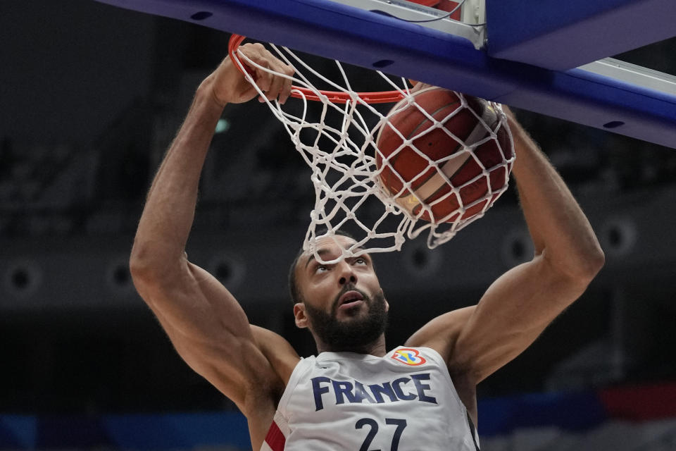 France center Rudy Gobert (27) dunks to score during the Basketball World Cup classification match between France and Iran at the Indonesia Arena stadium in Jakarta, Indonesia, Thursday, Aug. 31, 2023. (AP Photo/Dita Alangkara)