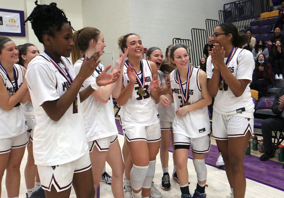 Salina Central's Aubrie Kierscht (35), right, walks out to receive her most valuable players award after Salina Central defeated Andover 56-36 in the Salina Invitational Tournament Saturday.