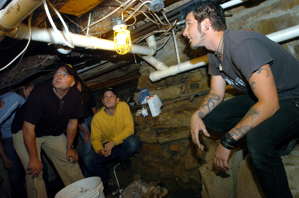 Cast of ghost hunters in a basement