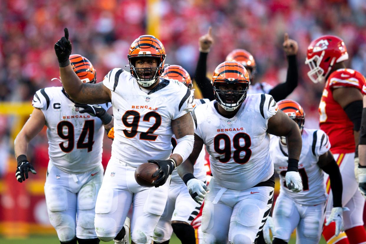 Cincinnati Bengals defensive end B.J. Hill (92) celebrates after intercepting a pass from Kansas City Chiefs quarterback Patrick Mahomes (15) in the fourth quarter the AFC championship NFL football game, Sunday, Jan. 30, 2022, at GEHA Field at Arrowhead Stadium in Kansas City, Mo. Cincinnati Bengals defeated Kansas City Chiefs 27-24.