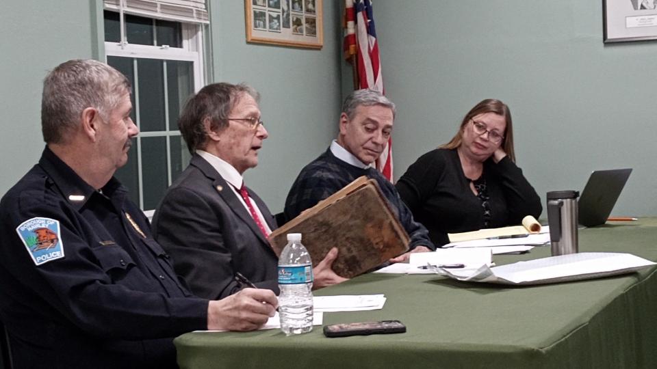 Hawley Mayor John Nichols holds the original borough minutes book from 1884 to 1897 as he discusses the ledger, presumed lost forever, with the council, Jan. 2, 2024. Having been unexpectedly presented with the book by the family of the late Mayor Ann Morgan, he said he plans to hand it over to the borough once it is reviewed by the county historian. From left are Police Chief Daniel Drake, Nichols and councilors Joseph Faubel and Michele Rojas, at borough hall. Councilor Elaine Herzog suggested that the borough donate it to the Wayne County Historical Society for archival preservation.