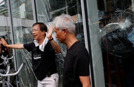 Lawmakers Kwok Ka-ki and Leung Yiu-chung talk to protesters as they try to break into the Legislative Council building during the anniversary of Hong Kong's handover to China in Hong Kong