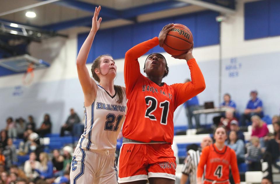 Beaver Falls Avina Norman gets fouled by Ellwood City's Delaney Sturgeon while attempting a layup during the first half Thursday night at Lincoln High School.