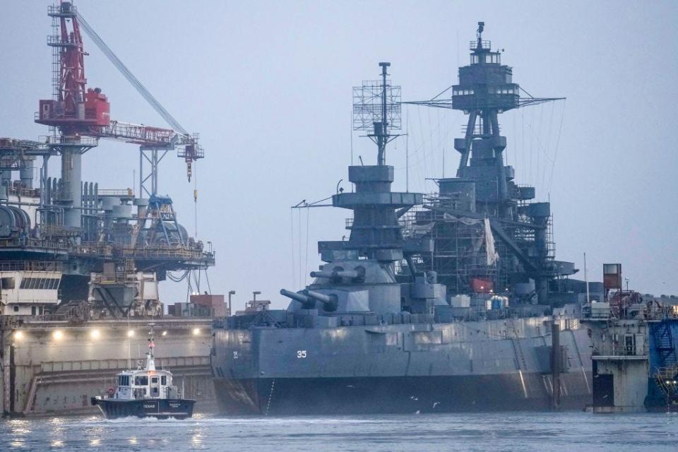 The Battleship Texas emerges from the fog as it is removed from a drydock on Tuesday, March 5, 2024 in Galveston.