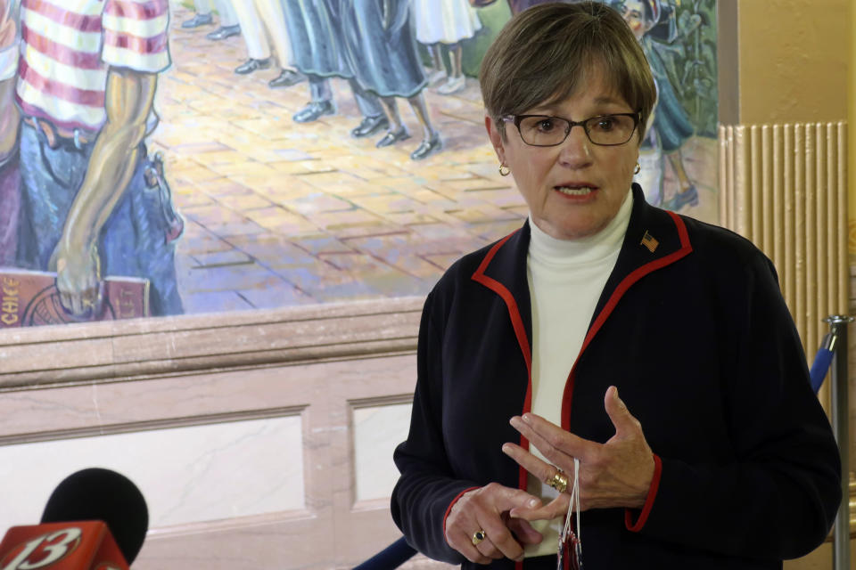 Kansas Gov. Laura Kelly answers questions from reporters about the coronavirus pandemic after a meeting with legislative leaders, Thursday, July 2, 2020, at the Statehouse in Topeka, Kan. Kelly has issued an order to require people to wear masks in public and at their workplaces. (AP Photo/John Hanna)