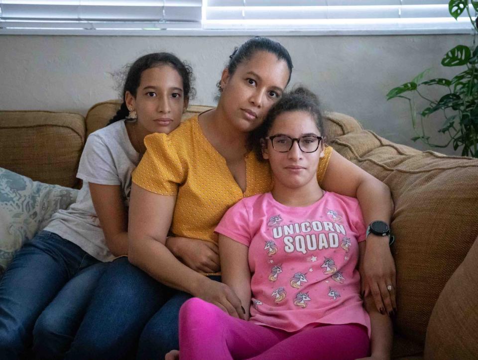 Thirteen-year-old Sakura Hernandez (r) with her mother Charisma and twin sister Akira. Sakura has cerebral palsy, autism, ADD, and scoliosis.