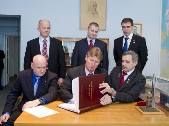 NASA astronaut Scott Kelly (front, left) and Russian cosmonauts Gennady Padalka (front, center) and Mikhail Kornienko (front, right) of the Russian Federal Space Agency Roscosmos join their backup crewmembers in the preserved office of first co