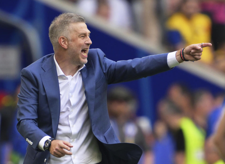 Romania's head coach Edward Iordanescu gives instructions from the side line during a Group E match between Romania and Ukraine at the Euro 2024 soccer tournament in Munich, Germany, Monday, June 17, 2024. (Peter Kneffel/dpa via AP)