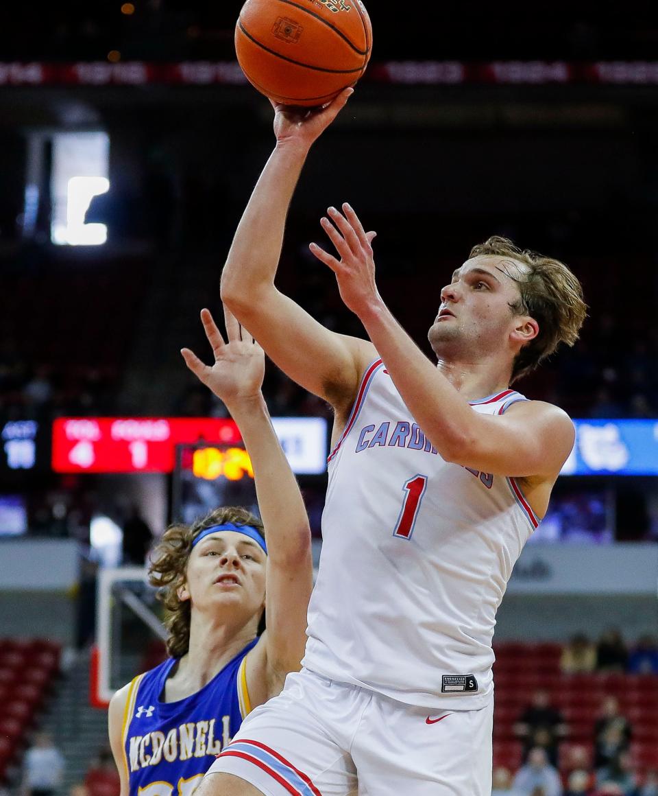 Newman Catholic's Mason Prey (1) puts up a shot against McDonell Central Catholic during the WIAA Division 5 boys basketball state championship game Saturday at the Kohl Center in Madison.