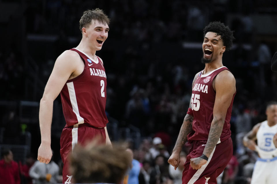 Alabama forward Grant Nelson (2) and guard Aaron Estrada (55) celebrate after win over North Carolina in a Sweet 16 college basketball game in the NCAA tournament Thursday, March 28, 2024, in Los Angeles. (AP Photo/Ashley Landis)