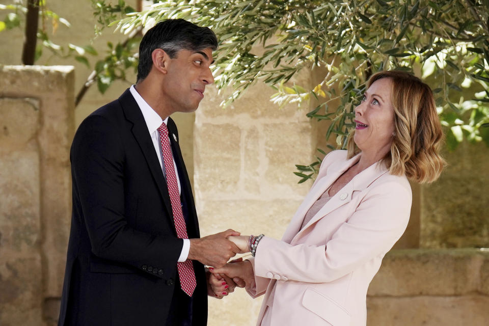 FILE - British Prime Minister Rishi Sunak, left, is welcomed by Italian Prime Minister Giorgia Meloni during a G7 world leaders summit at Borgo Egnazia, southern Italy, Thursday, June 13, 2024. (Christopher Furlong/Pool Photo via AP, File)