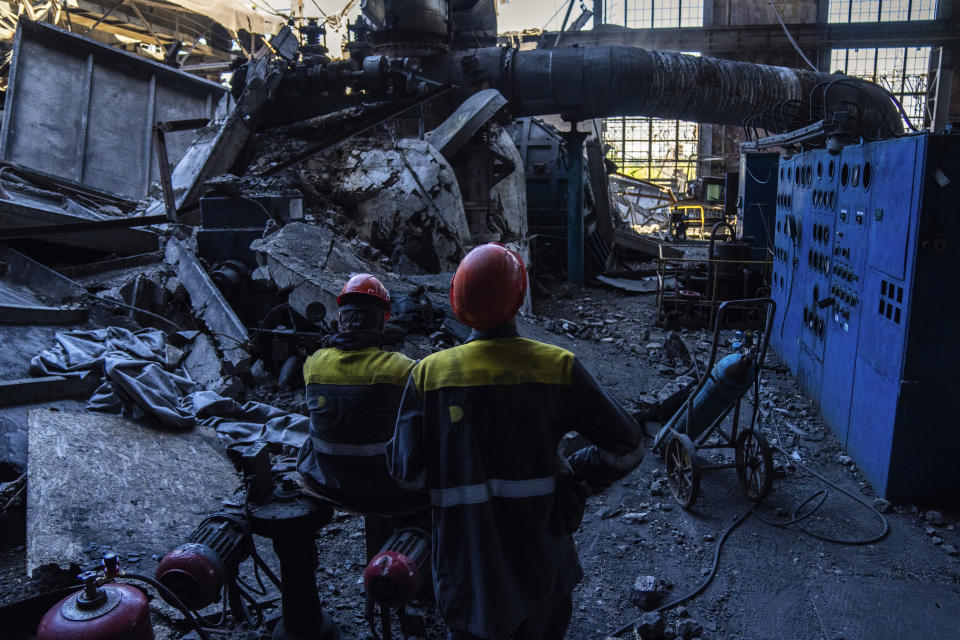 Workers stand among debris in a damaged DTEK thermal power plant after a Russian attack in Ukraine, Thursday, May 2, 2024. Ukrainian energy workers are struggling to repair the damage from intensifying airstrikes aimed at pulverizing Ukraine's energy grid, hobbling the economy and sapping the public's morale. (AP Photo/Francisco Seco)