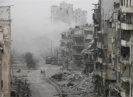 Smoke rises from buildings after what activists said was shelling from forces loyal to Syria's President Bashar al-Assad in the besieged area of Homs January 15, 2014. REUTERS/Thaer Al Khalidiya /Files