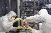 Laser Interferometer Gravitational-wave Observatory (LIGO) technicians work on optics in this undated photo released by Caltech/MIT/LIGO Laboratory on February 8, 2016. REUTERS/Caltech/MIT/LIGO Laboratory/Handout via Reuters