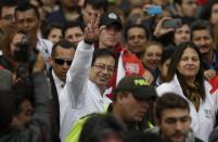 El restituido alcalde de Bogotá Gustavo Petro, centro, saluda a sus seguidores al llegar a la alcaldía en Bogotá, Colombia, el miéroles 23 de abril de 2014. (AP Photo/Fernando Vergara)