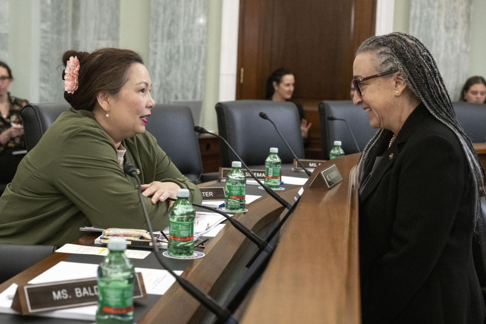 Sen. Tammy Duckworth, D-Ill., left, talks with Dr. Tracy Dillinger, Manager for Safety Culture and Human Factors, National Aeronautics and Space Administration before the start of a Senate Commerce, Science, and Transportation hearing to examine the FAA Organization Designation Authorization (ODA) Expert Panel Report on Wednesday, April 17, 2024, in Washington. (AP Photo/Kevin Wolf)