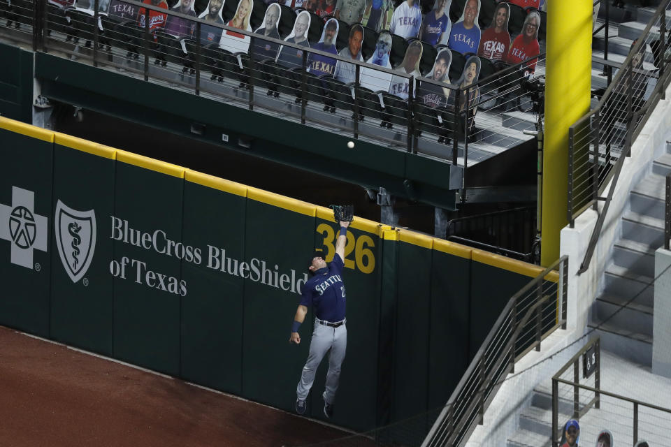 Seattle Mariners right fielder Dylan Moore is unable to reach a run-scoring triple by Texas Rangers' Willie Calhoun in the first inning of a baseball game in Arlington, Texas, Monday, Aug. 10, 2020. The hit scored Shin-Soo Choo. (AP Photo/Tony Gutierrez)