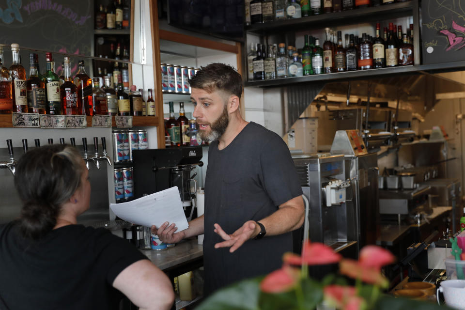 In this Thursday, Sept. 12, 2019 photo, Chris Miles helps to prepare his restaurant, Batesy's, for opening in the Rockaway section of New York. Miles and his partners were ready to open their new, seaside barbecue joint just in time for the summer season when they got stunning news: There would be no gas to fuel the fryers, griddles and stoves. National Grid has imposed a moratorium on new gas hookups in parts of New York City, saying it can’t meet rising demand without the new pipeline. (AP Photo/Seth Wenig)