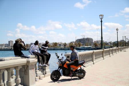 Libyan youths are seen at the coast of the Mediterranean Sea in Tripoli, Libya April 12, 2019. REUTERS/Ahmed Jadallah