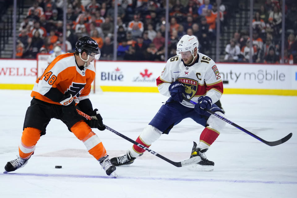 Florida Panthers' Aleksander Barkov, right, and Philadelphia Flyers' Morgan Frost chase the puck during the first period of an NHL hockey game, Tuesday, March 21, 2023, in Philadelphia. (AP Photo/Matt Slocum)