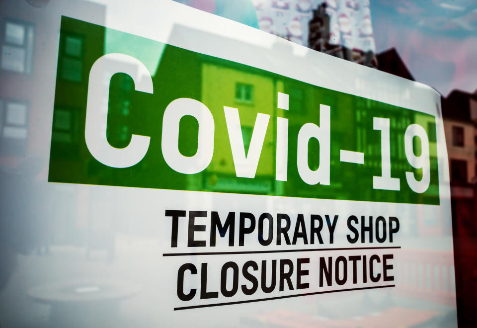 Green COVID-19 shop sign in show window